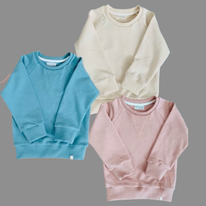 The Children’s French Terry Crew in misty rose, cameo blue, and creme.